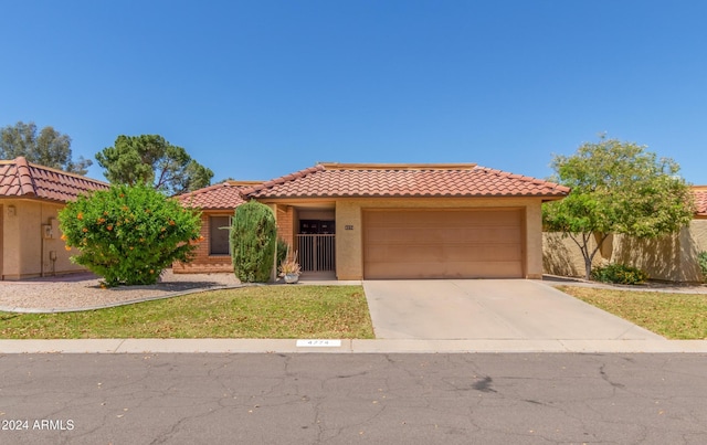 mediterranean / spanish-style home with a garage