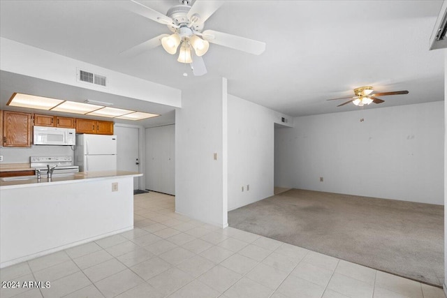 interior space featuring light carpet and ceiling fan