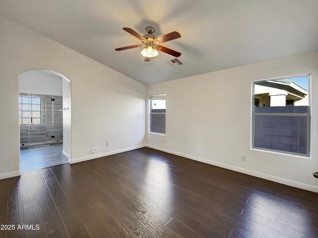 spare room with lofted ceiling, dark hardwood / wood-style floors, and ceiling fan