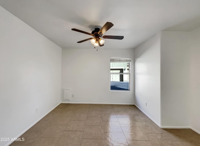 spare room with light tile patterned floors and ceiling fan