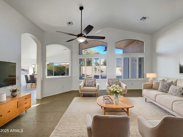 living room featuring tile patterned flooring, lofted ceiling, and ceiling fan