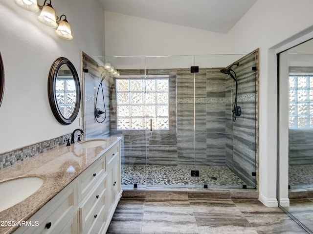 bathroom featuring vanity, an enclosed shower, and vaulted ceiling