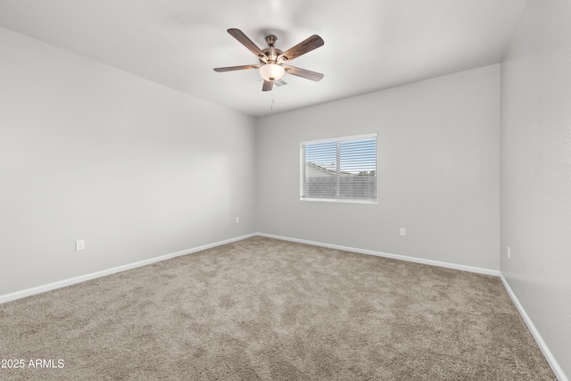 spare room featuring ceiling fan and carpet