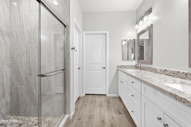 bathroom featuring an enclosed shower and vanity