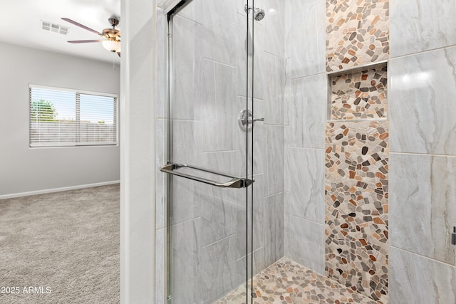 bathroom with an enclosed shower and ceiling fan