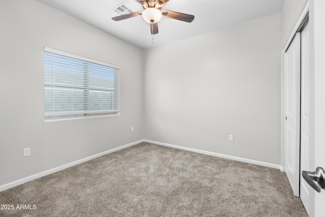 unfurnished bedroom featuring light carpet, ceiling fan, and a closet