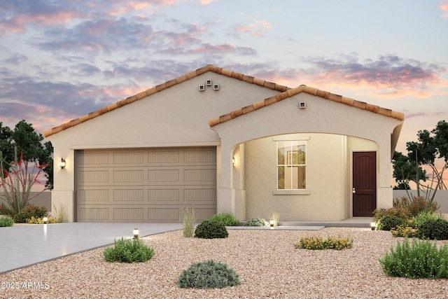 1989 S 246th Ln, Buckeye, AZ 85326 - mediterranean / spanish-style home featuring stucco siding, a garage, and driveway