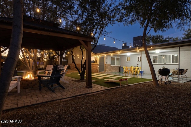 view of yard with an outdoor fire pit and a patio area