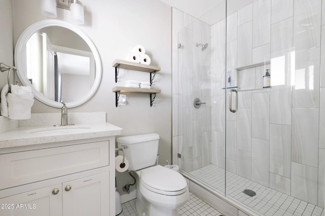 bathroom with tile patterned flooring, an enclosed shower, vanity, and toilet