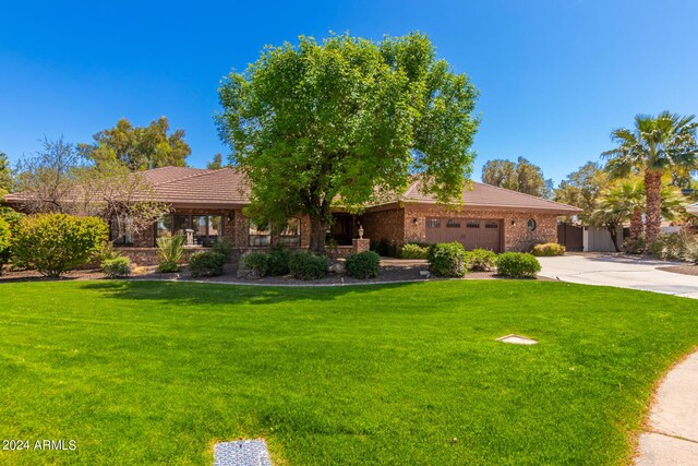 view of front of property with a front yard and a garage