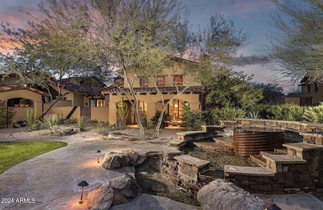 view of patio terrace at dusk