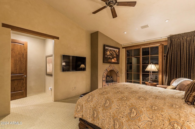 carpeted bedroom with ceiling fan and vaulted ceiling