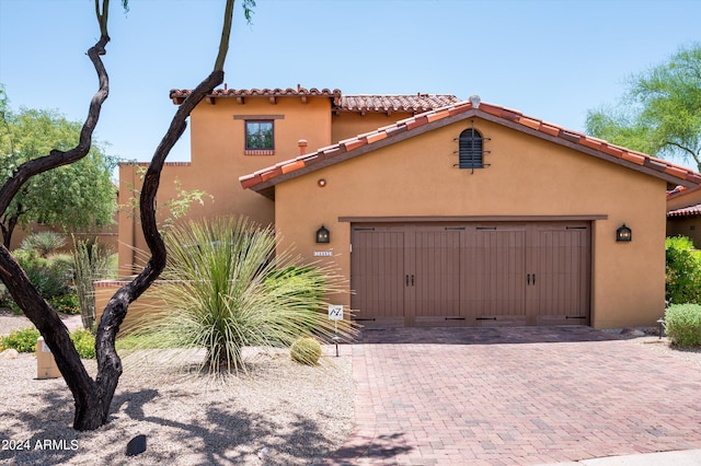 mediterranean / spanish-style house with a garage