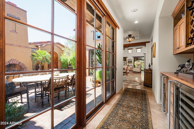 corridor featuring light tile patterned flooring and wine cooler