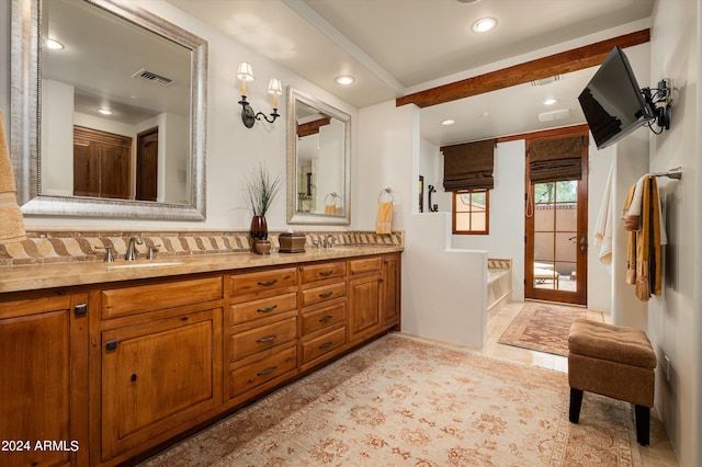 bathroom featuring tile patterned flooring and double vanity