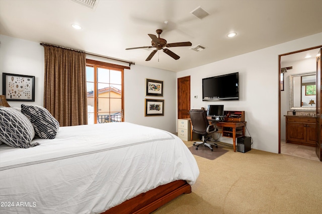 bedroom with multiple windows, ensuite bath, light colored carpet, and ceiling fan