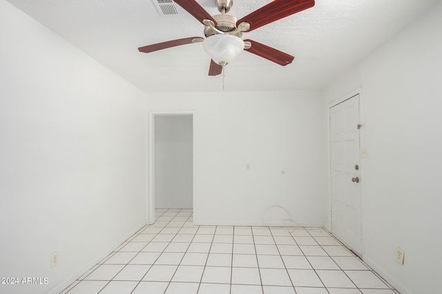 tiled empty room with ceiling fan