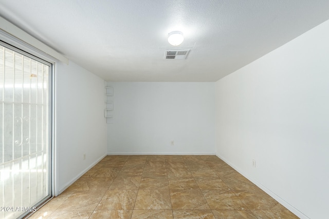 empty room with tile patterned floors