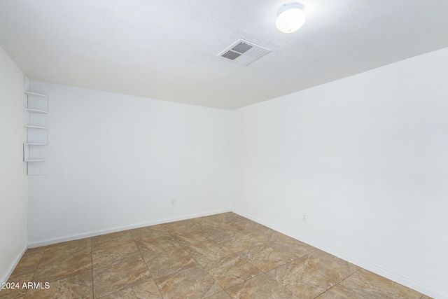 unfurnished room with light tile patterned floors