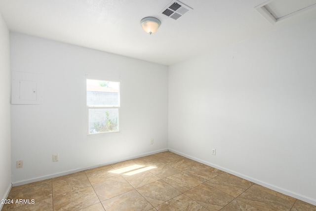 tiled empty room with electric panel