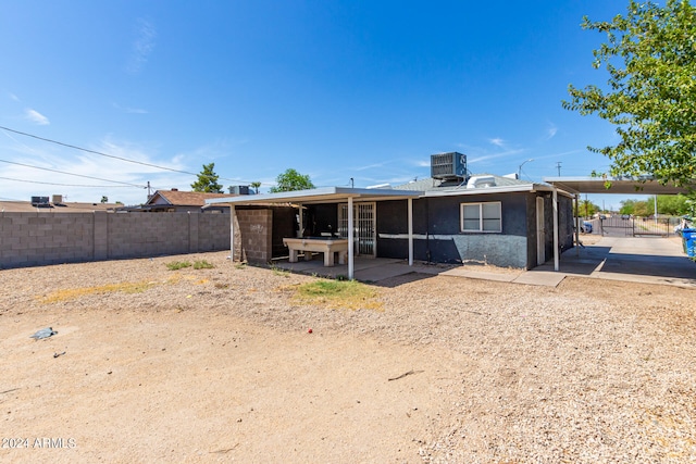 rear view of house featuring a patio area and cooling unit