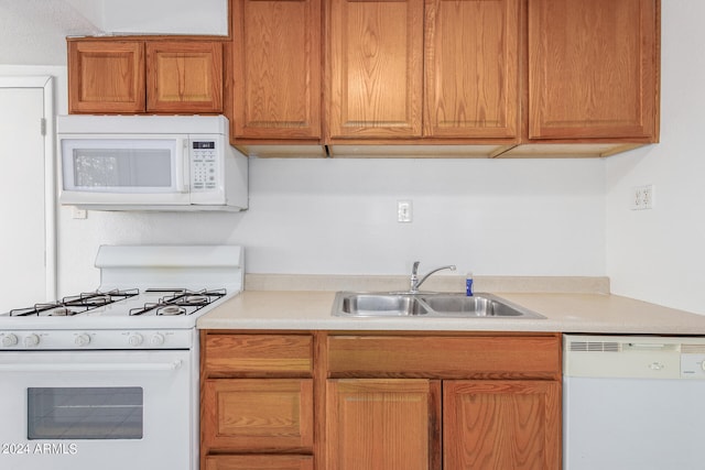 kitchen with sink and white appliances