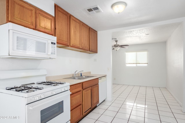 kitchen with sink, a textured ceiling, white appliances, ceiling fan, and light tile patterned flooring