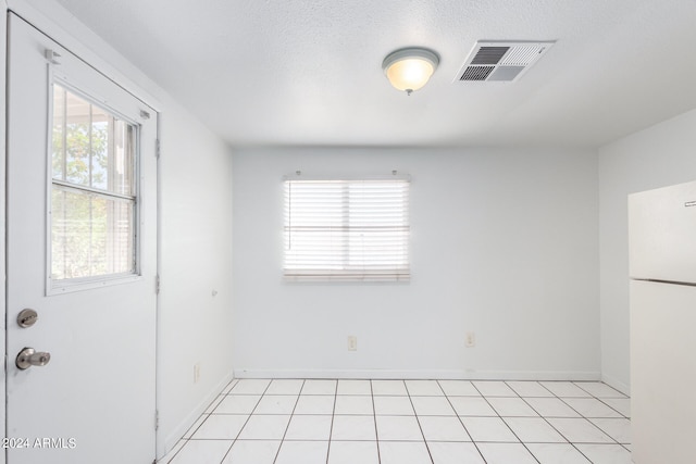 unfurnished room with light tile patterned floors