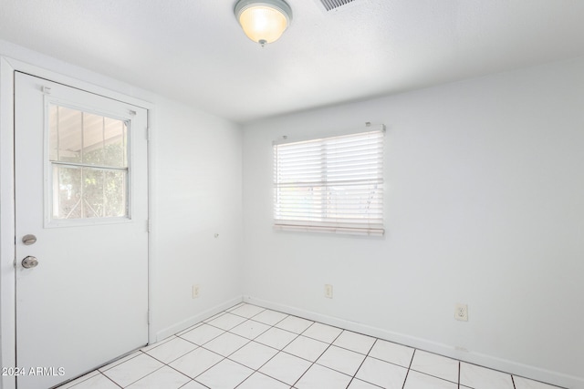 spare room with light tile patterned floors