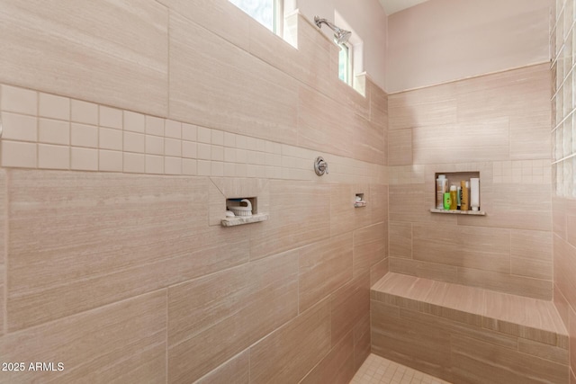 bathroom with a tile shower