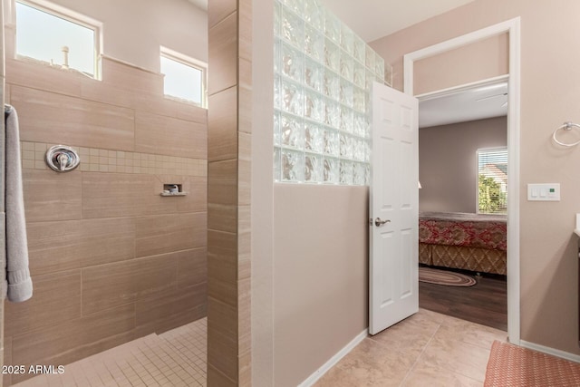 bathroom with tile patterned floors and tiled shower