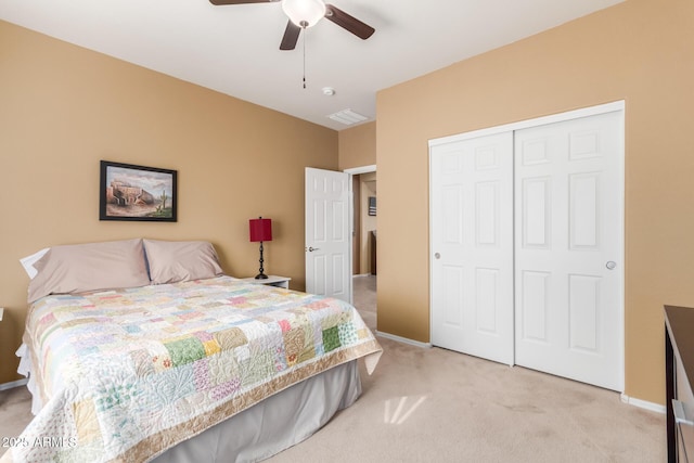 carpeted bedroom featuring a closet and ceiling fan