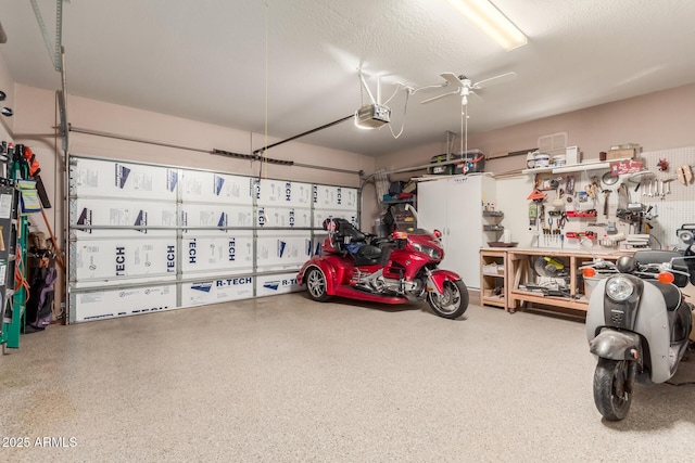 garage featuring a garage door opener and a workshop area