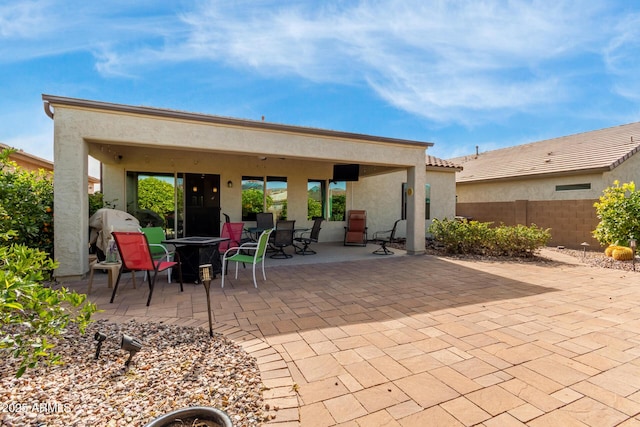 back of house with a patio