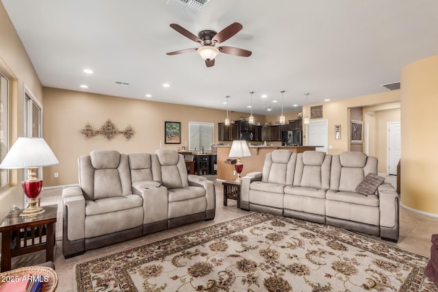 tiled living room featuring ceiling fan