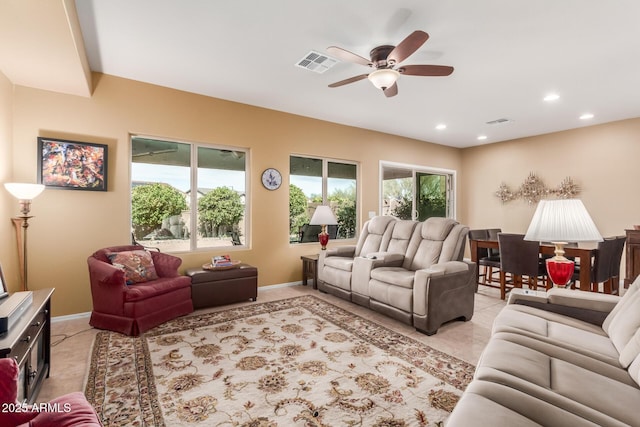 living room with ceiling fan and a wealth of natural light