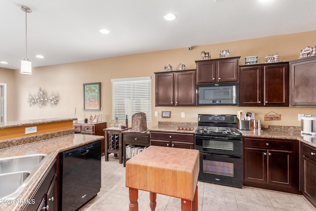 kitchen with sink, dark brown cabinets, black appliances, light tile patterned flooring, and decorative light fixtures