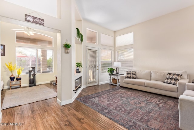 living room featuring a high ceiling and dark hardwood / wood-style flooring