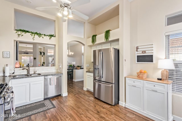 kitchen featuring white cabinetry, appliances with stainless steel finishes, sink, and hardwood / wood-style floors