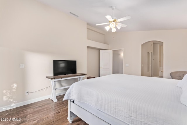 bedroom featuring vaulted ceiling, dark hardwood / wood-style floors, and ceiling fan