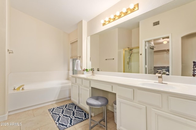 bathroom featuring shower with separate bathtub, tile patterned floors, and vanity