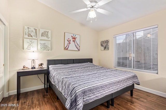 bedroom featuring dark hardwood / wood-style flooring, lofted ceiling, and ceiling fan