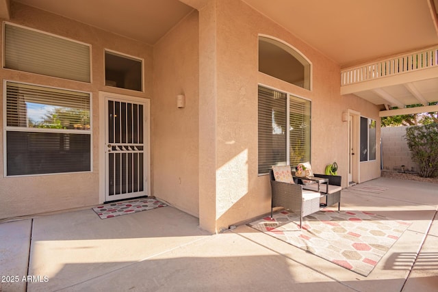 view of exterior entry featuring a patio