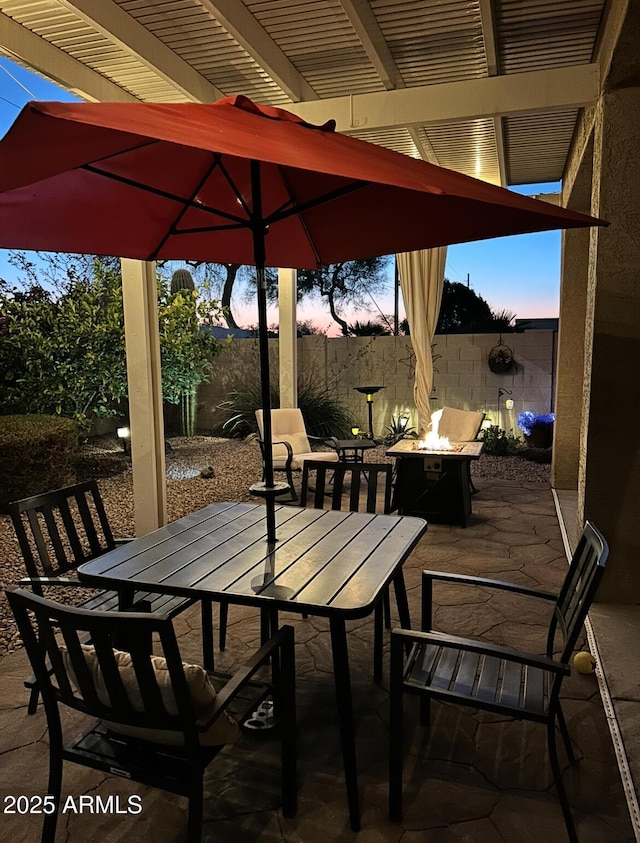 patio terrace at dusk with an outdoor fire pit