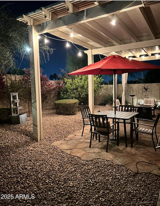 patio at twilight featuring a pergola