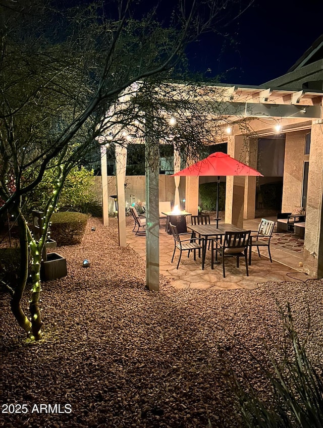 patio at twilight with an outdoor fire pit