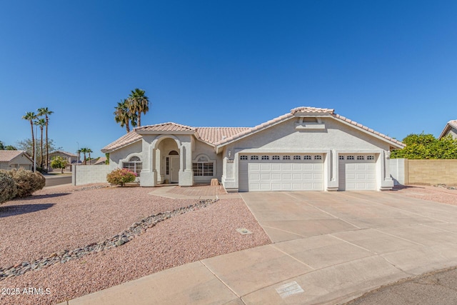 mediterranean / spanish-style home with a garage