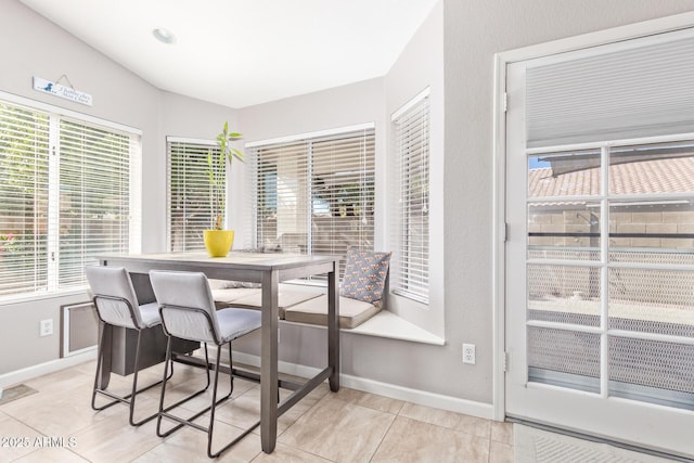 dining area featuring light tile patterned flooring