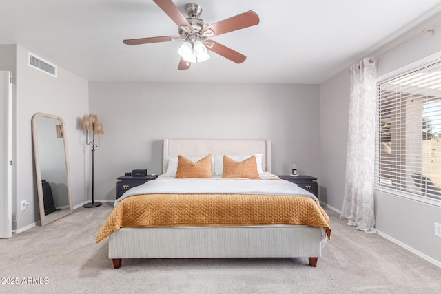 bedroom featuring light carpet and ceiling fan