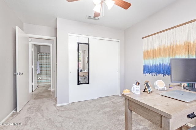 carpeted office space featuring ceiling fan